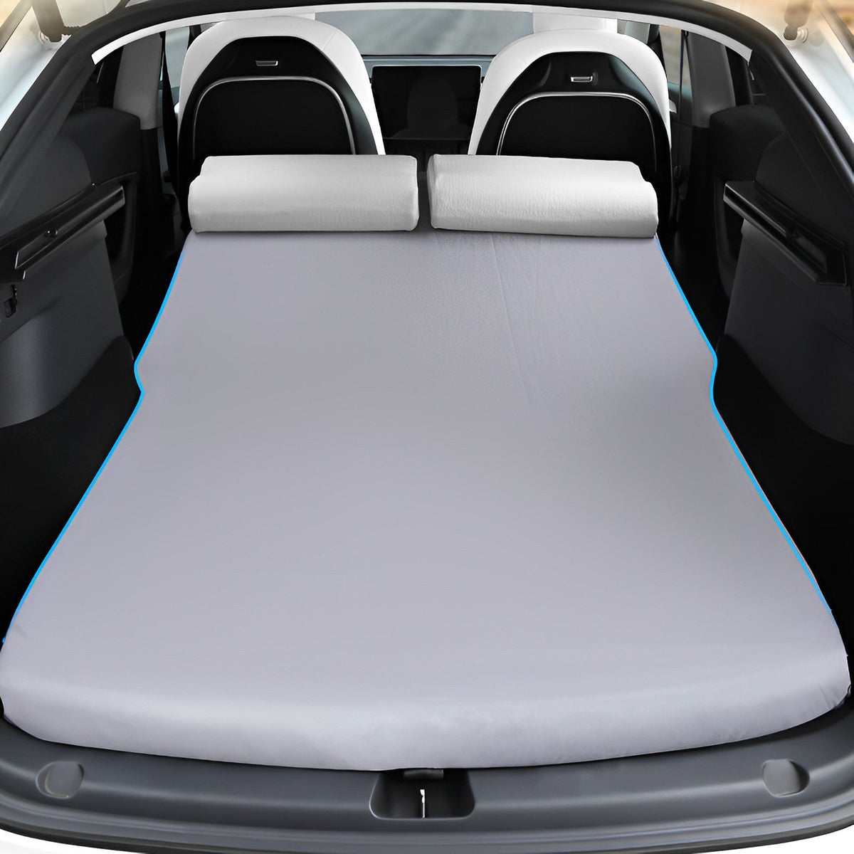 Foam camping mattress shown across a folded Tesla rear-seat and cargo area