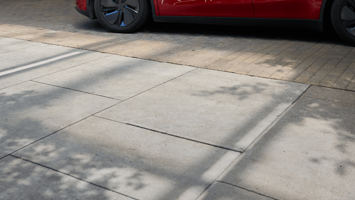 Red Tesla Model Y Robotaxi photographed for the Cybercab launch event rider promotion