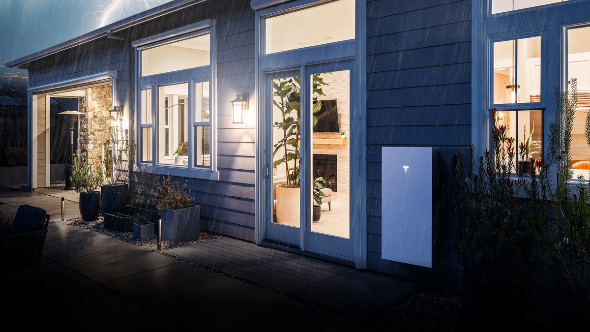 Tesla Powerwall 3 installed outside a home during storm conditions