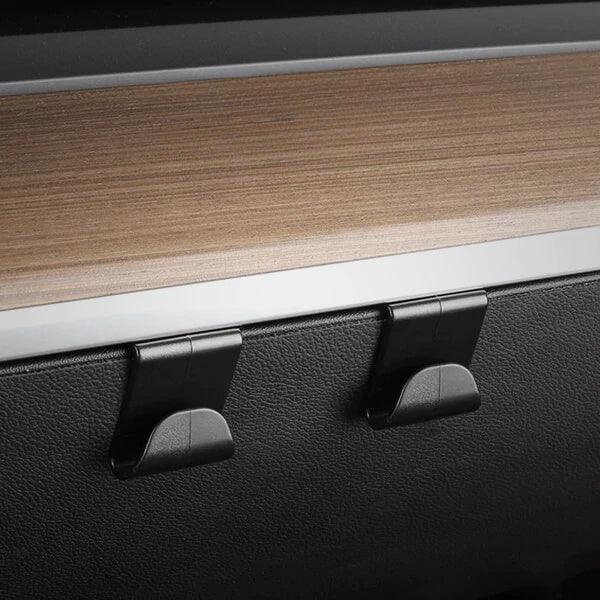 Pair of storage hooks installed inside a Tesla glove box