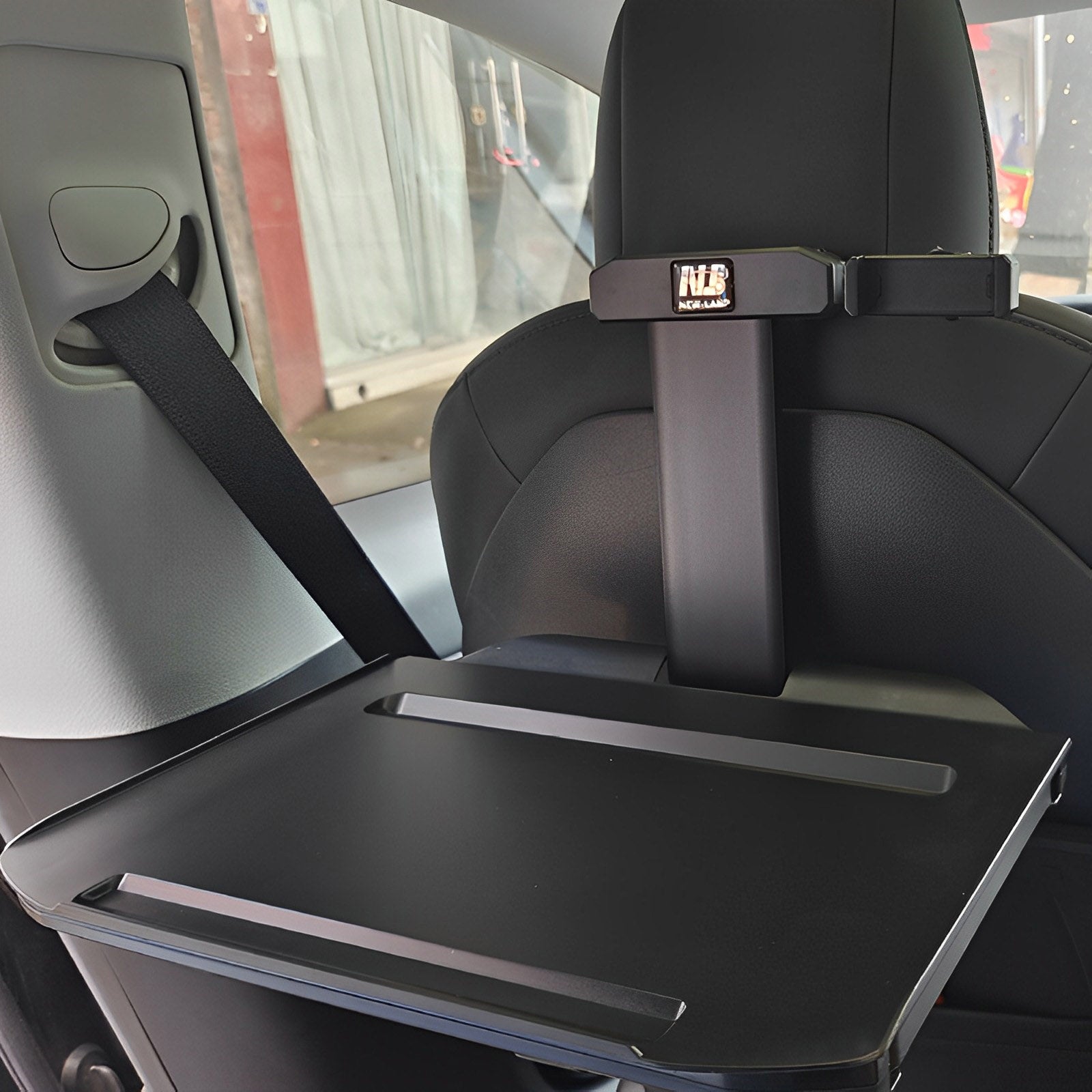 Seatback table installed behind a Tesla front seat