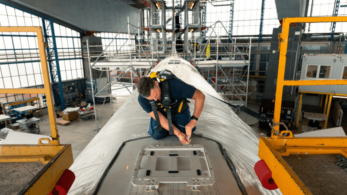 Lufthansa technician installing Starlink equipment on an Airbus A320neo