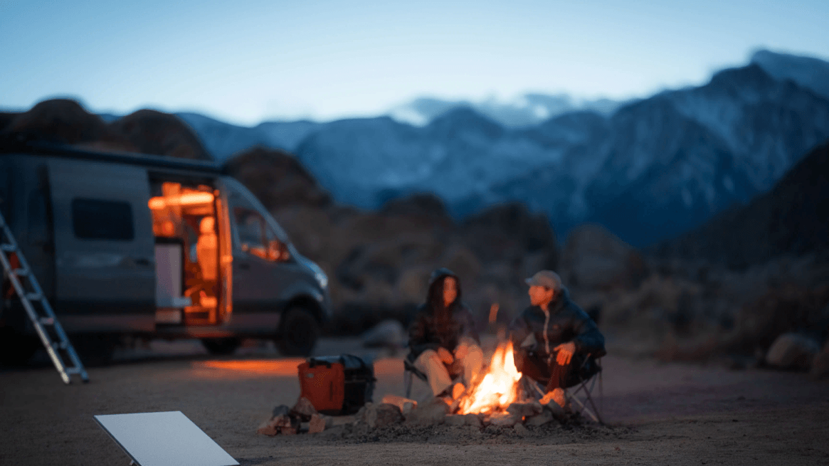 Starlink Mini used by travelers camping beside a van in the mountains