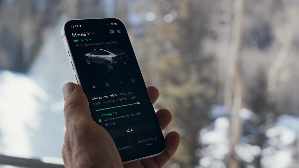 Tesla mobile app charging screen shown beside a vehicle in cold weather