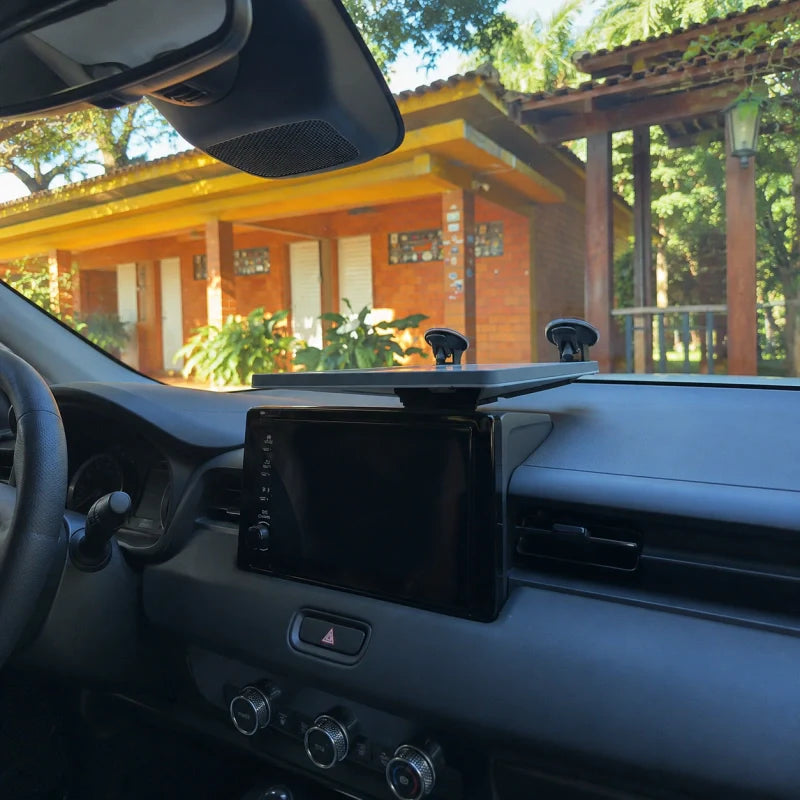 Starlink Mini mounted low on a vehicle dashboard with windshield suction cups and support base