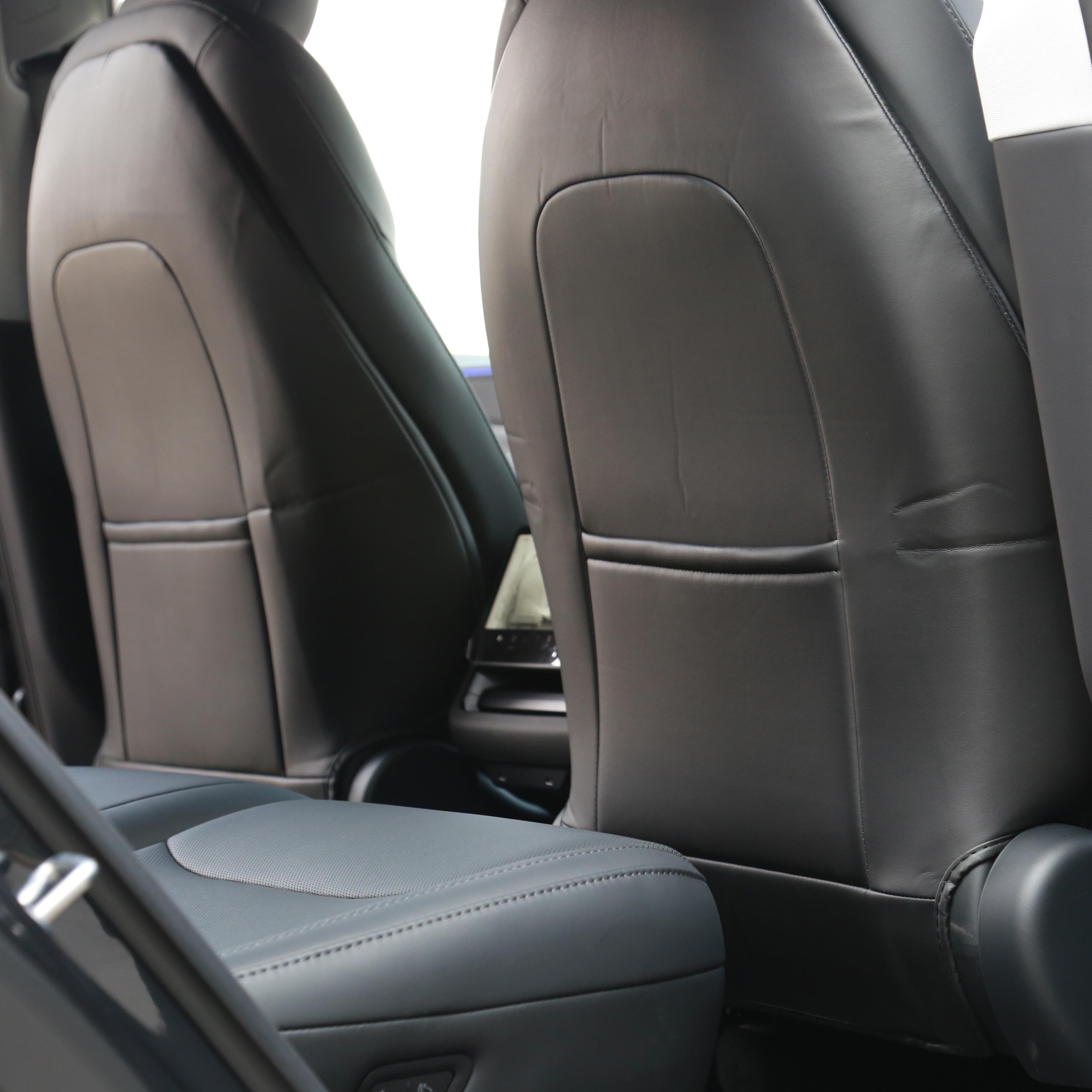 Seat back kick protectors installed in a Tesla