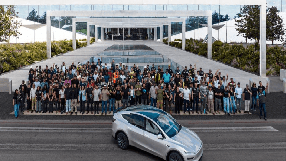 Tesla employees with a silver Model Y L during first builds at Gigafactory Texas