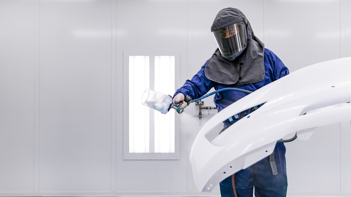 Tesla technician performing service work in an official Tesla facility